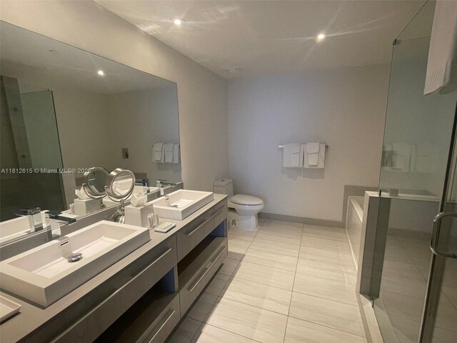4010 S Ocean Dr Unit R1705, Hollywood, FL 33019 - full bath featuring double vanity, a stall shower, toilet, a tub, and baseboards