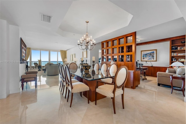 19955 NE 38th Ct Unit 2204, Aventura, FL 33180 - dining area featuring a tray ceiling, a chandelier, light tile patterned floors, and floor to ceiling windows