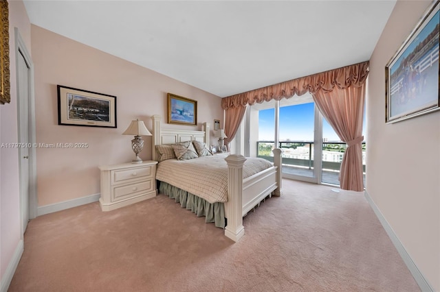 19955 NE 38th Ct Unit 2204, Aventura, FL 33180 - bedroom featuring access to outside, light carpet, and baseboards