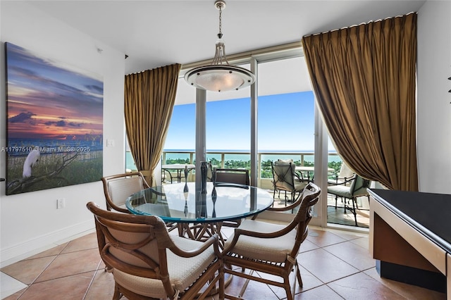 19955 NE 38th Ct Unit 2204, Aventura, FL 33180 - dining room featuring light tile patterned floors, plenty of natural light, a water view, and a wall of windows