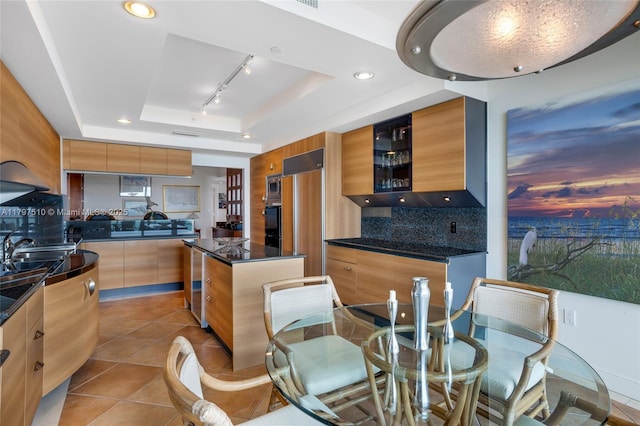 19955 NE 38th Ct Unit 2204, Aventura, FL 33180 - kitchen featuring a raised ceiling, modern cabinets, dark countertops, decorative backsplash, and built in appliances