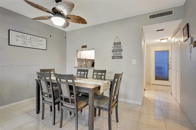 3170 Holiday Springs Blvd Unit 6-209, Margate, FL 33063 - dining area with light marble finish floors, a ceiling fan, and baseboards
