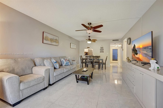 3170 Holiday Springs Blvd Unit 6-209, Margate, FL 33063 - living area with light marble finish flooring, a ceiling fan, and a textured ceiling