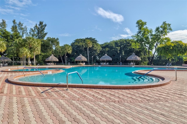 3170 Holiday Springs Blvd Unit 6-209, Margate, FL 33063 - community pool featuring a patio area and view of wooded area