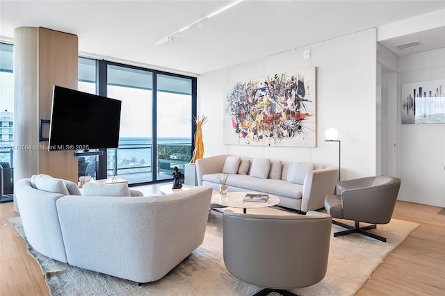 8701 Collins Ave Unit 905, Miami Beach, FL 33154 - living room featuring floor to ceiling windows, light wood-type flooring, and track lighting