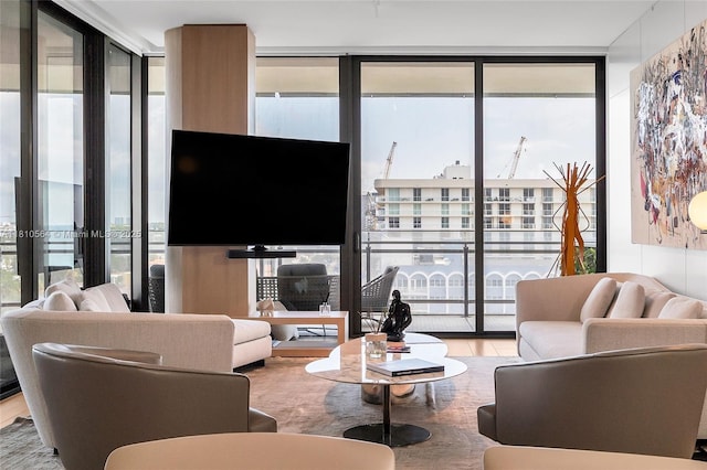 8701 Collins Ave Unit 905, Miami Beach, FL 33154 - living area featuring floor to ceiling windows and wood finished floors