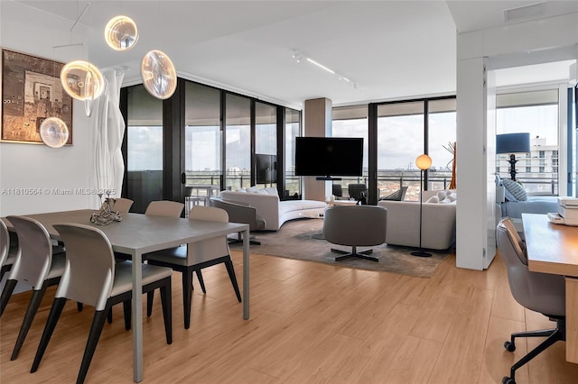 8701 Collins Ave Unit 905, Miami Beach, FL 33154 - dining area with light wood-type flooring, healthy amount of natural light, and floor to ceiling windows