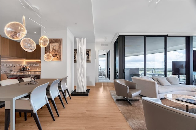 8701 Collins Ave Unit 905, Miami Beach, FL 33154 - living room featuring expansive windows and light wood finished floors