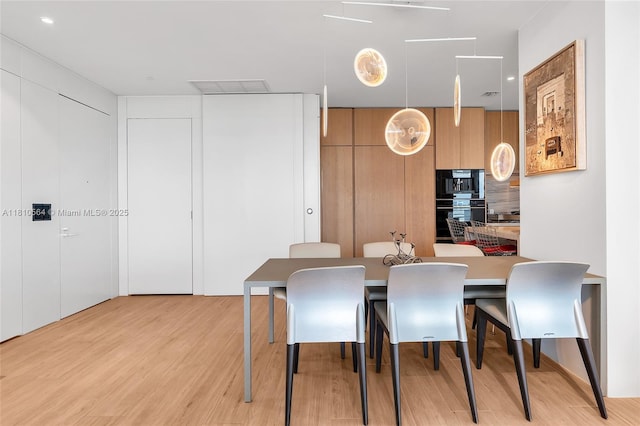 8701 Collins Ave Unit 905, Miami Beach, FL 33154 - dining room with light wood finished floors