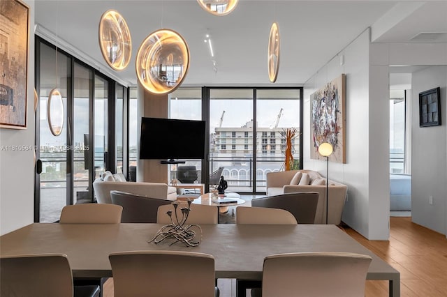 8701 Collins Ave Unit 905, Miami Beach, FL 33154 - dining area with wood finished floors and expansive windows