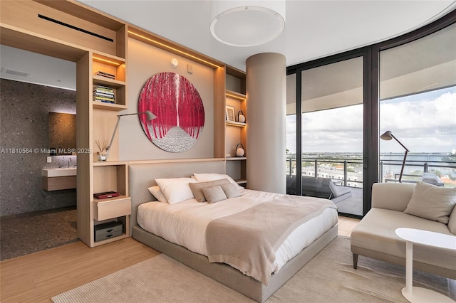 8701 Collins Ave Unit 905, Miami Beach, FL 33154 - bedroom with access to outside, wood finished floors, and floor to ceiling windows