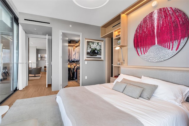 8701 Collins Ave Unit 905, Miami Beach, FL 33154 - bedroom featuring wood finished floors, a walk in closet, and a closet