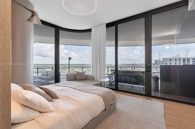 8701 Collins Ave Unit 905, Miami Beach, FL 33154 - bedroom with a wall of windows, access to outside, and wood finished floors