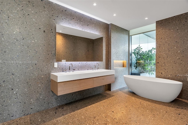 8701 Collins Ave Unit 905, Miami Beach, FL 33154 - bathroom featuring double vanity, recessed lighting, a soaking tub, and tile walls