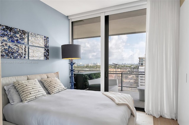 8701 Collins Ave Unit 905, Miami Beach, FL 33154 - bedroom with floor to ceiling windows, access to exterior, wood finished floors, and a view of city