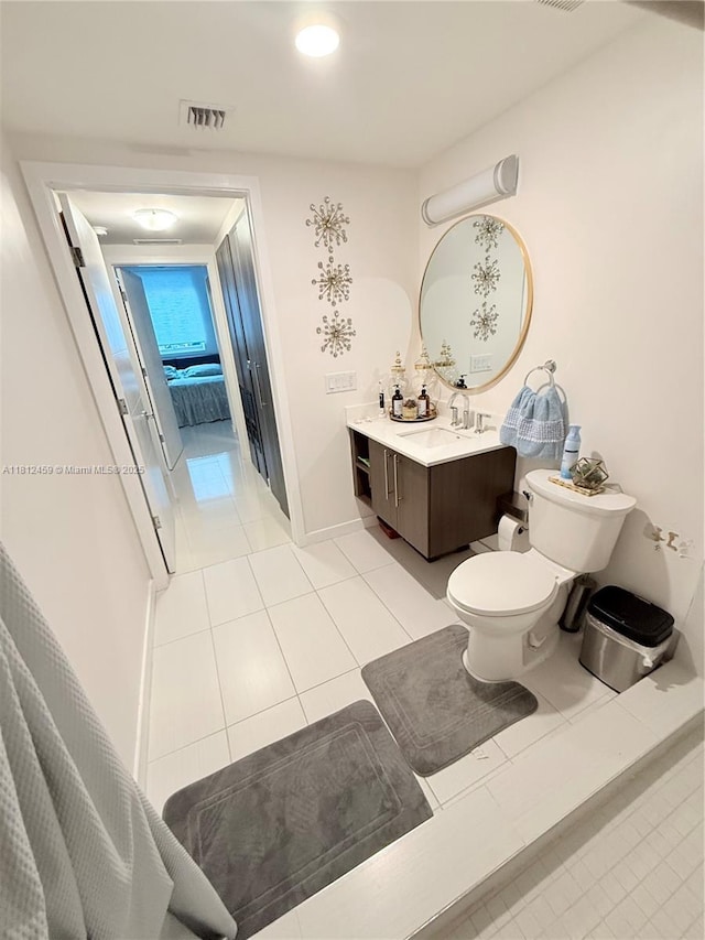 7661 NW 107th Ave Unit 303, Doral, FL 33178 - bathroom featuring tile patterned flooring, vanity, toilet, and baseboards