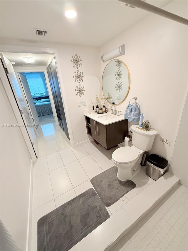 7661 NW 107th Ave Unit 303, Doral, FL 33178 - bathroom with vanity, tile patterned floors, toilet, and baseboards