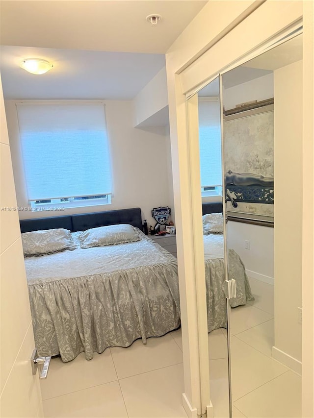 7661 NW 107th Ave Unit 303, Doral, FL 33178 - bedroom with tile patterned floors and a closet