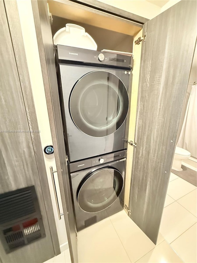 7661 NW 107th Ave Unit 303, Doral, FL 33178 - laundry room featuring stacked washing machine and dryer and tile patterned flooring