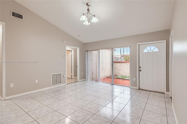 20316 NW 32nd Path, Miami Gardens, FL 33056 - entrance foyer featuring lofted ceiling, a chandelier, light tile patterned floors, baseboards, and a textured ceiling
