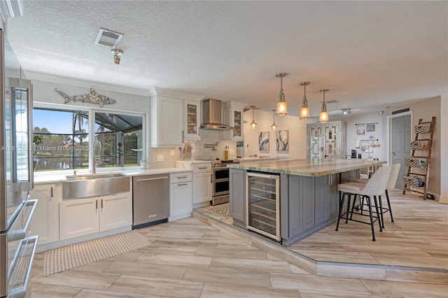 2750 SW 86th Way, Davie, FL 33328 - kitchen with stainless steel appliances, beverage cooler, wall chimney exhaust hood, a sink, and white cabinets