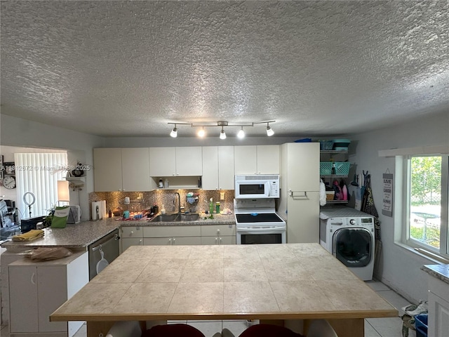 85 NW 126th St, North Miami, FL 33168 - kitchen with a sink, white appliances, washer / dryer, tasteful backsplash, and a textured ceiling
