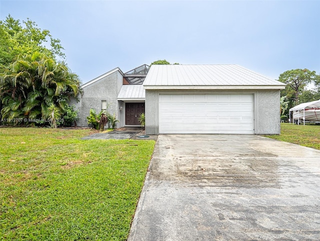 802 SE Kendall Ave, Port St Lucie, FL 34983 - mid-century inspired home with stucco siding, a front lawn, metal roof, driveway, and a garage