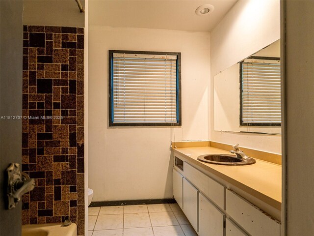 802 SE Kendall Ave, Port St Lucie, FL 34983 - bathroom featuring toilet, vanity, tile patterned flooring, and tub / shower combination