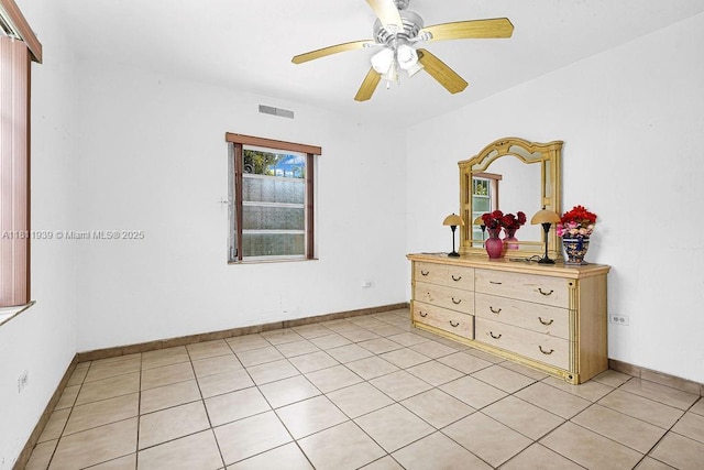 911 E 9th Pl, Hialeah, FL 33010 - bedroom with light tile patterned floors, ceiling fan, and baseboards