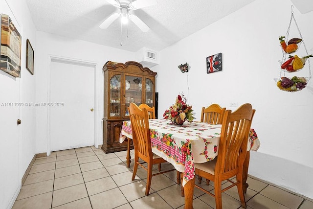 911 E 9th Pl, Hialeah, FL 33010 - dining room with light tile patterned flooring, a textured ceiling, and ceiling fan