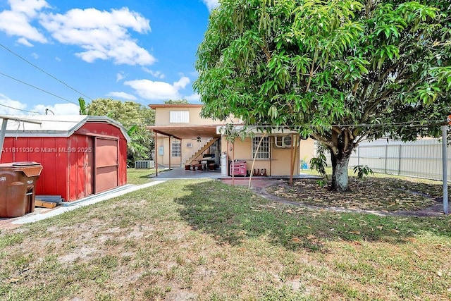 911 E 9th Pl, Hialeah, FL 33010 - rear view of property with a patio, stairs, central AC, and stucco siding