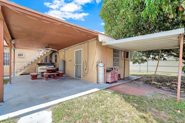 911 E 9th Pl, Hialeah, FL 33010 - view of patio / terrace featuring stairs, ceiling fan, and water heater