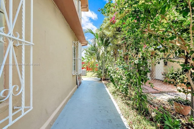 911 E 9th Pl, Hialeah, FL 33010 - view of side of home with stucco siding and cooling unit