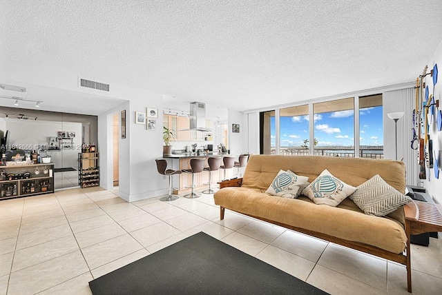 18041 Biscayne Blvd Unit 1201, Aventura, FL 33160 - living area with a textured ceiling, light tile patterned floors, baseboards, and rail lighting