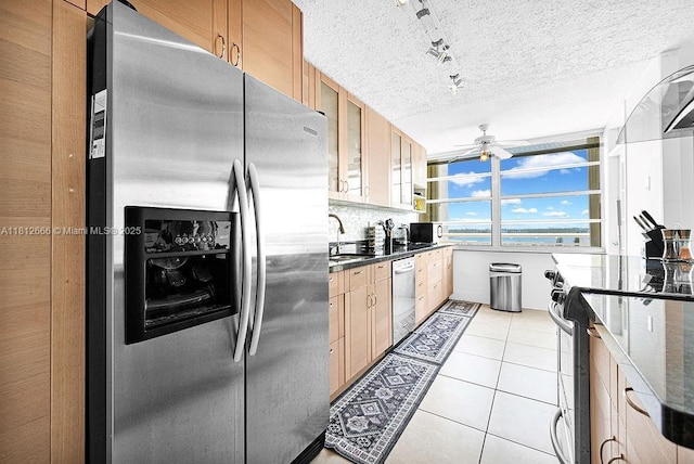 18041 Biscayne Blvd Unit 1201, Aventura, FL 33160 - kitchen with appliances with stainless steel finishes, a ceiling fan, a sink, track lighting, and light tile patterned floors