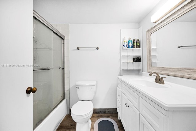 18041 Biscayne Blvd Unit 1201, Aventura, FL 33160 - bathroom featuring vanity, wood finished floors, toilet, and combined bath / shower with glass door