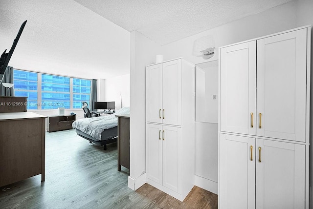 18041 Biscayne Blvd Unit 1201, Aventura, FL 33160 - bedroom with a textured ceiling and wood finished floors