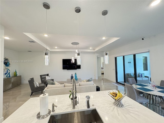 5444 SW Saint Armands Way, Westlake, FL 33470 - kitchen featuring a sink, recessed lighting, a tray ceiling, baseboards, and open floor plan