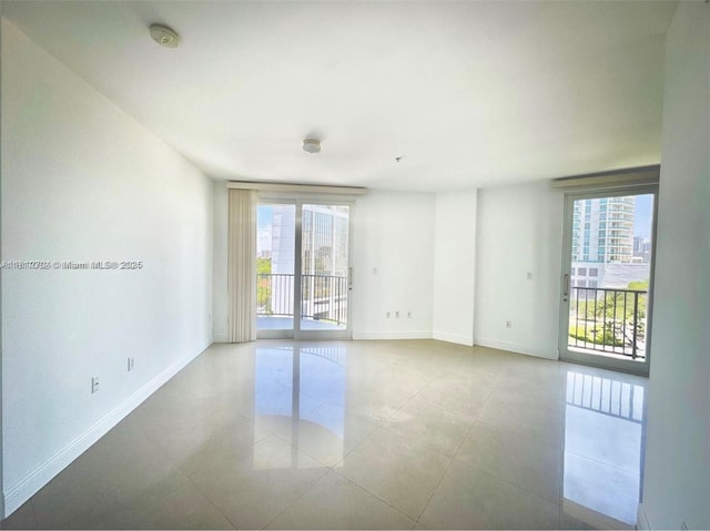 2701 SW 3rd Ave Unit 503, Miami, FL 33129 - unfurnished room with a smoke detector, baseboards, and light tile patterned floors