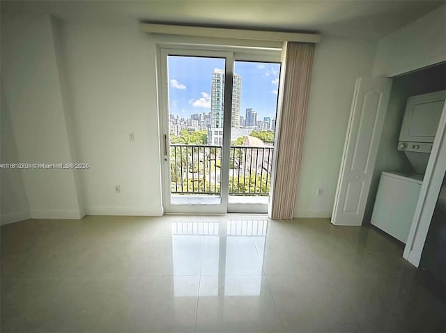 2701 SW 3rd Ave Unit 503, Miami, FL 33129 - empty room featuring baseboards, tile patterned flooring, and a view of city