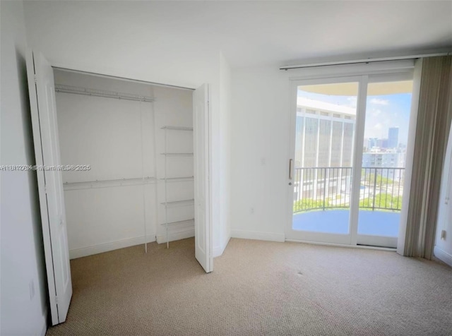 2701 SW 3rd Ave Unit 503, Miami, FL 33129 - unfurnished bedroom with carpet flooring, a closet, access to exterior, and baseboards
