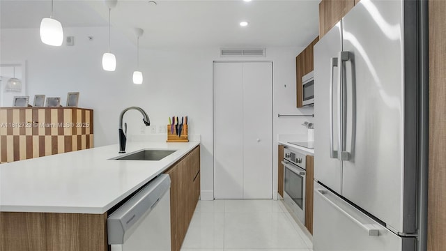 488 NE 18th St Unit 4208, Miami, FL 33132 - kitchen with appliances with stainless steel finishes, a sink, brown cabinets, modern cabinets, and a peninsula