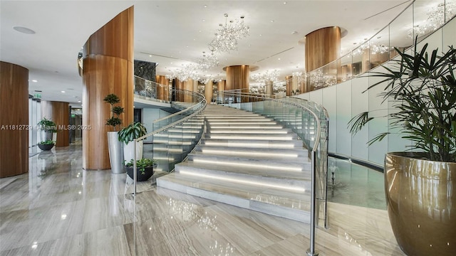 488 NE 18th St Unit 4208, Miami, FL 33132 - staircase featuring a chandelier and marble tiled floors