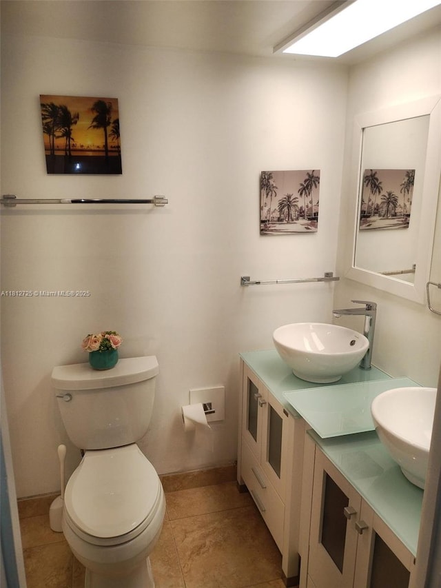 3300 N Palm Aire Dr Unit 706, Pompano Beach, FL 33069 - bathroom with toilet, double vanity, tile patterned floors, and baseboards