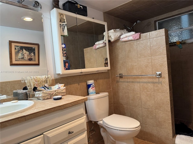 3750 NE 169th St Unit 106, North Miami Beach, FL 33160 - full bathroom with tile walls, tiled shower, vanity, and toilet
