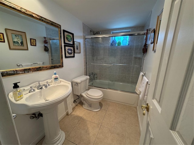 3750 NE 169th St Unit 106, North Miami Beach, FL 33160 - bathroom featuring toilet, shower / bath combination with glass door, and tile patterned floors