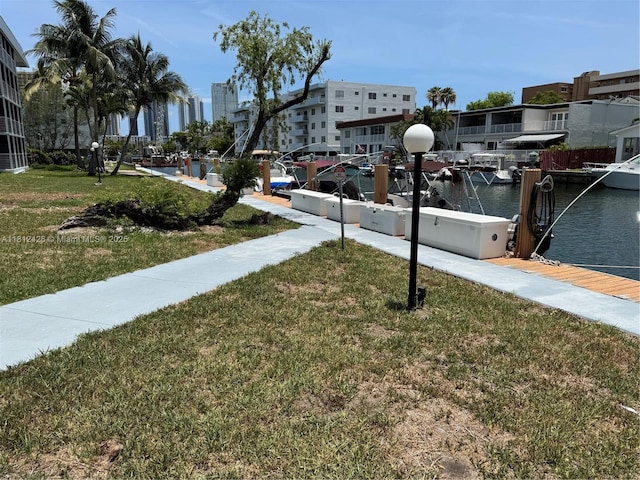 3750 NE 169th St Unit 106, North Miami Beach, FL 33160 - view of green lawn featuring a water view and a boat dock