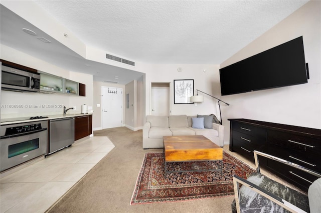 1900 N Bayshore Dr Unit 3605, Miami, FL 33132 - living room with a textured ceiling, light colored carpet, bar area, baseboards, and light tile patterned flooring