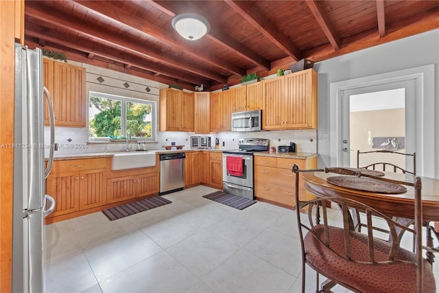 25000 SW 197th Ave, Homestead, FL 33031 - kitchen featuring appliances with stainless steel finishes, a sink, wooden ceiling with exposed beams, tasteful backsplash, and light countertops