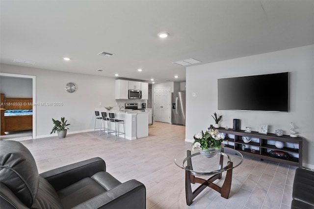 3021 June Cir Fl, LaBelle, FL 33935 - living room with light wood-type flooring, recessed lighting, and baseboards